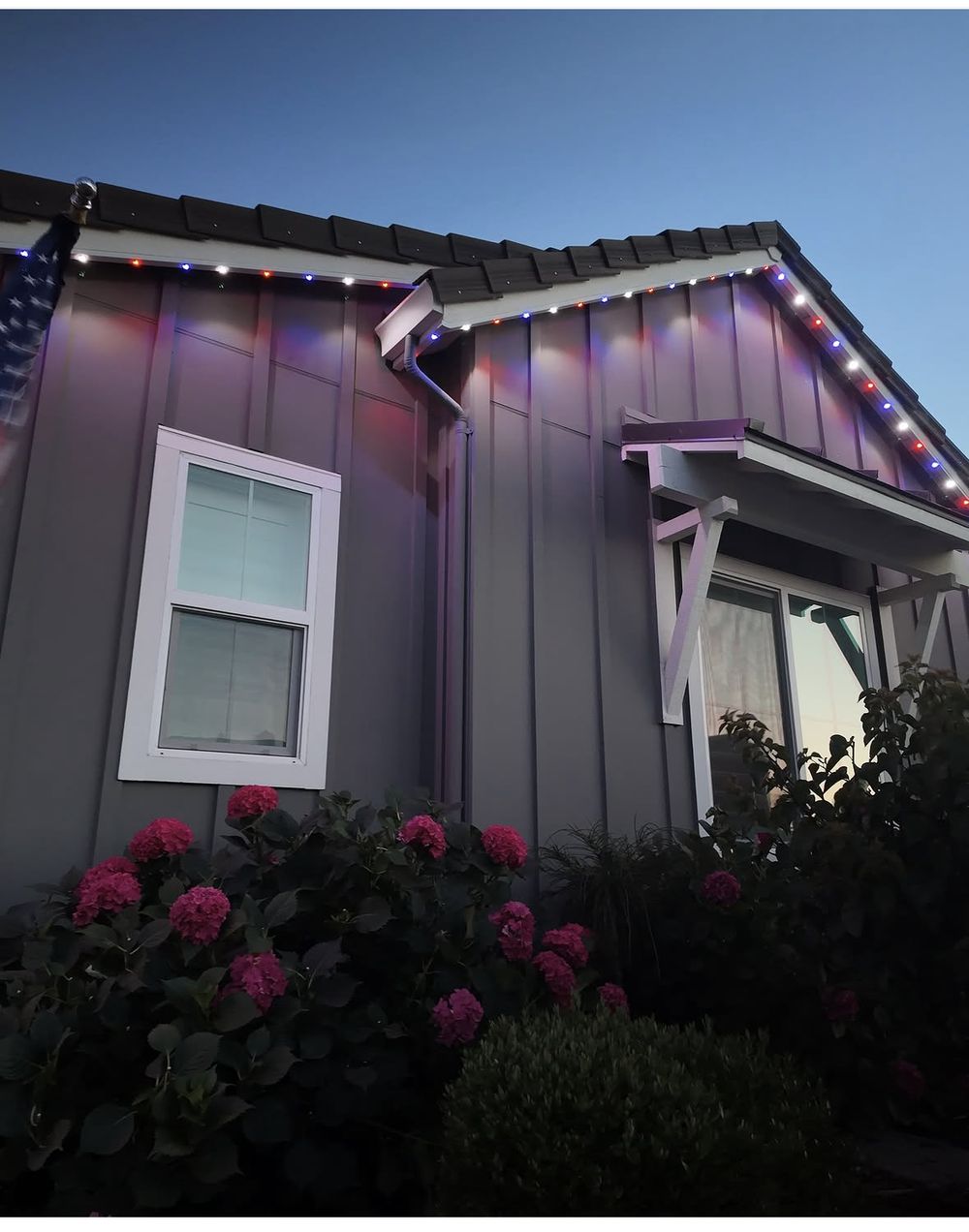 Close-up of color-changing permanent lighting fixtures along a roofline